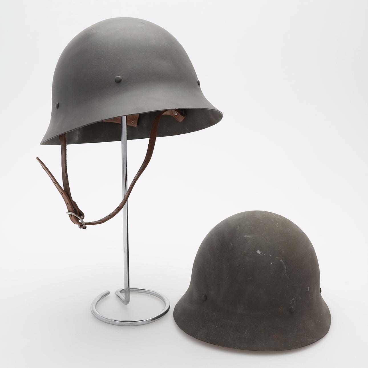 Two steel helmets, marked, 20th century.