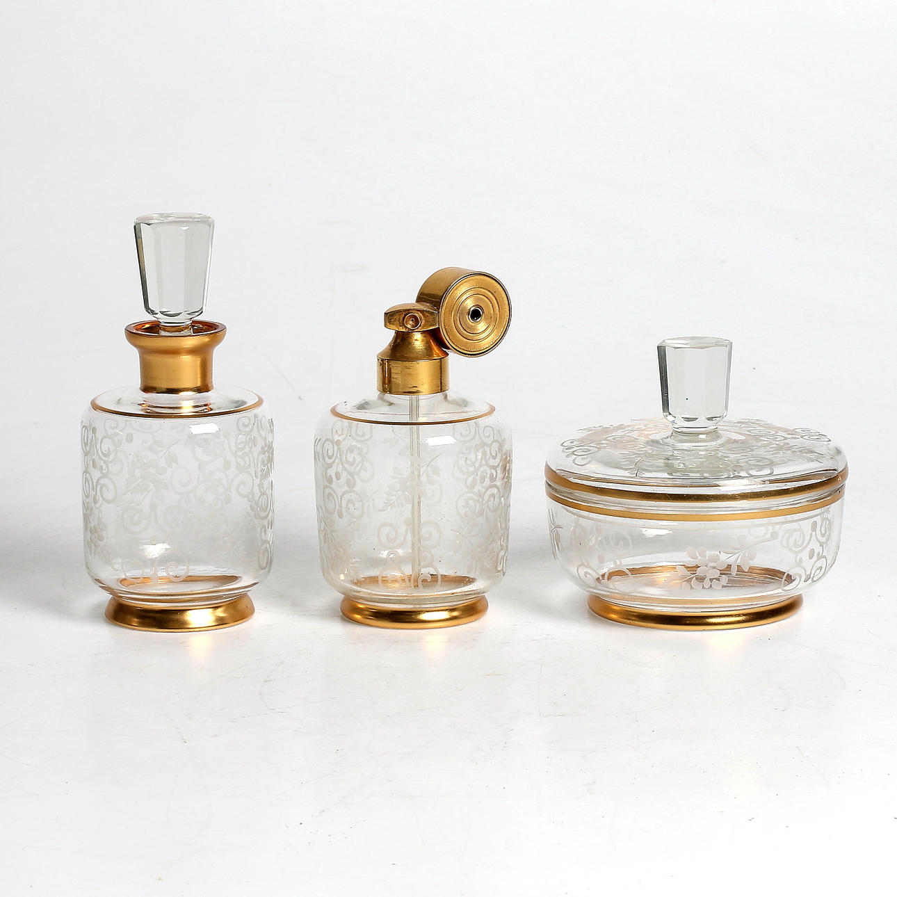 PARFYMFLASKOR samt LOCKSKÅL, 3 delar, glas, 1900-tal.