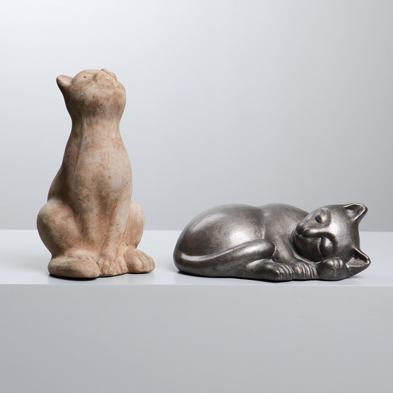 Two sculptures depicting cats, 2000's.
