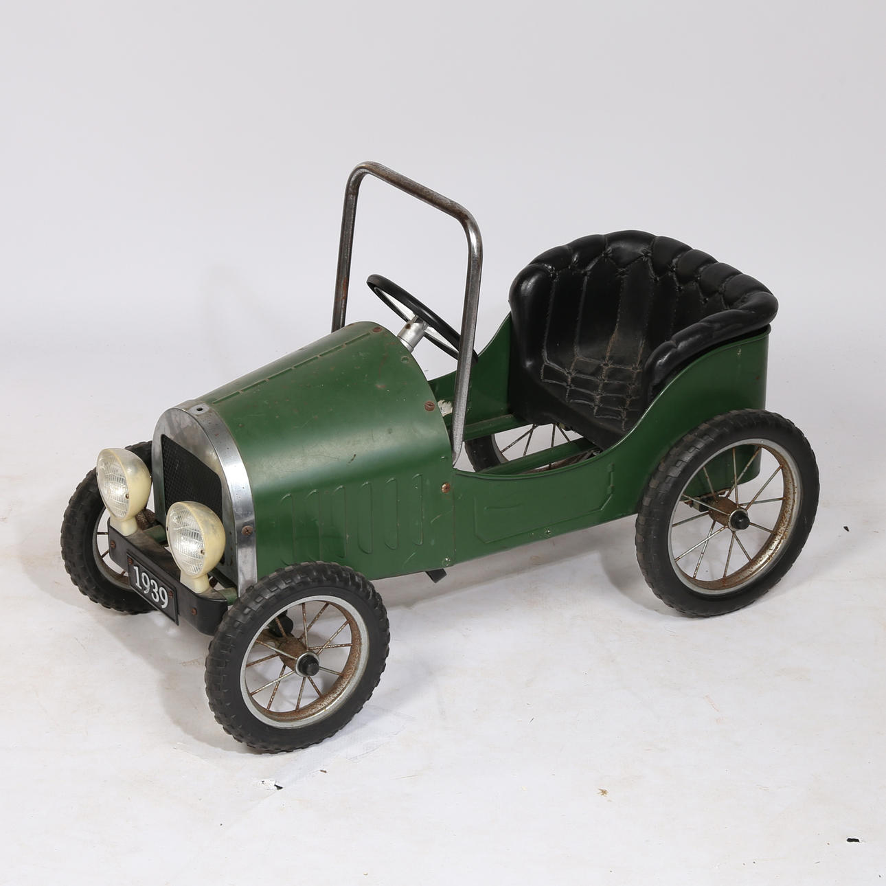 EIN TRETAUTO FÜR KINDER IN FORM EINES OLDTIMERS.