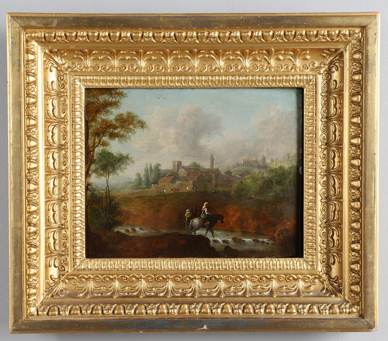 FOLLOWER OF GERRIT ADRIAENSZ. BERCKHEYDE (1638-1698). FIGURES WITH A HORSE CROSSING A RIVER, A TOWN BEYOND.