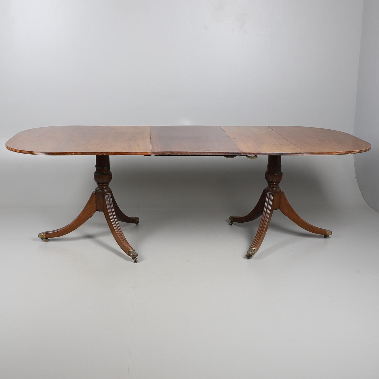 AN EDWARDIAN D-END DINING TABLE.