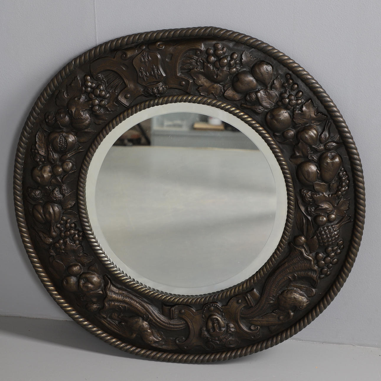 A CIRCULAR WALL MIRROR.