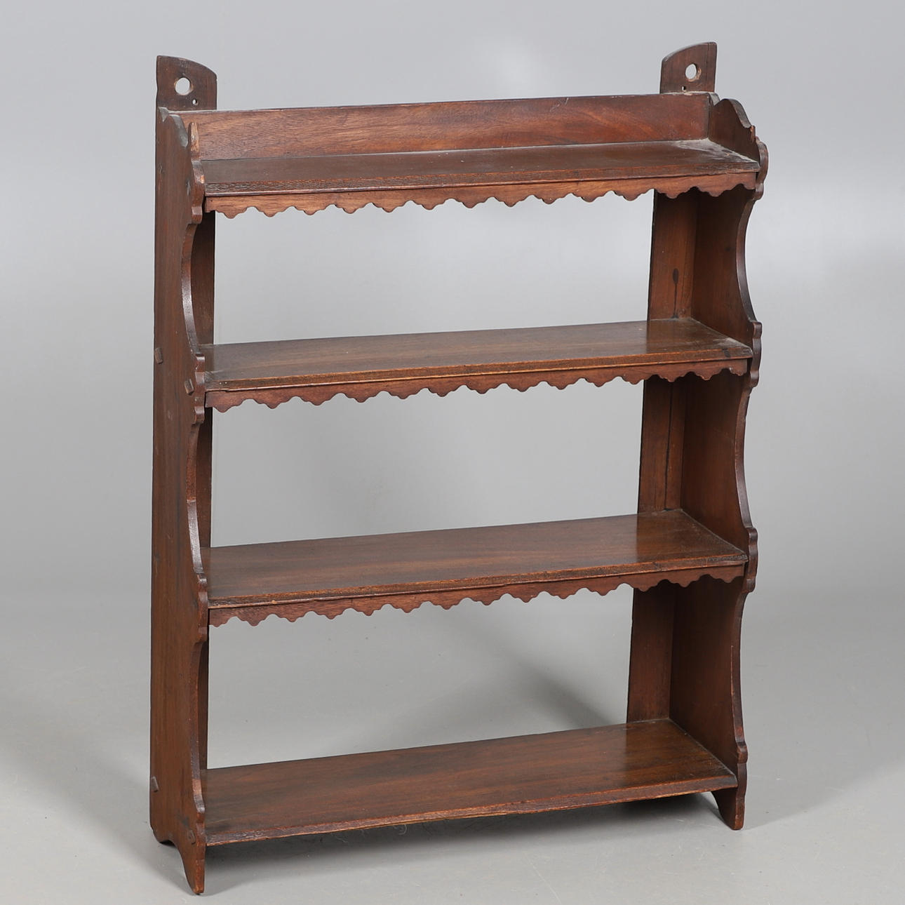 AN OAK WALL SHELF.