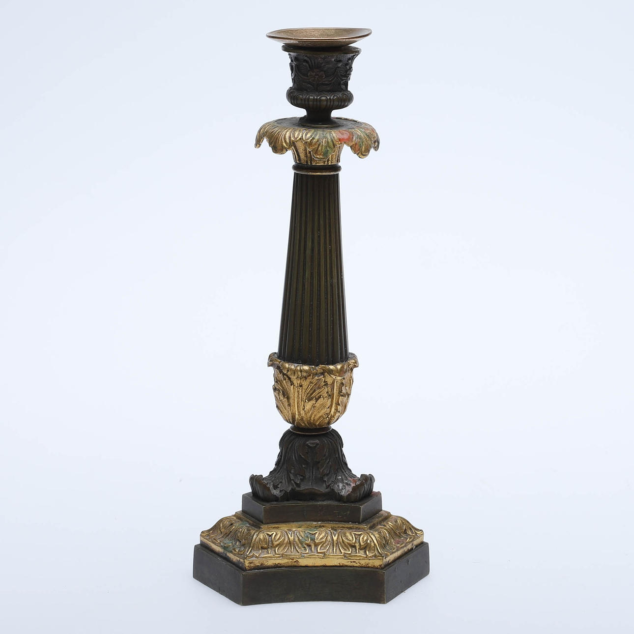 An empire candlestick, partly gilt.