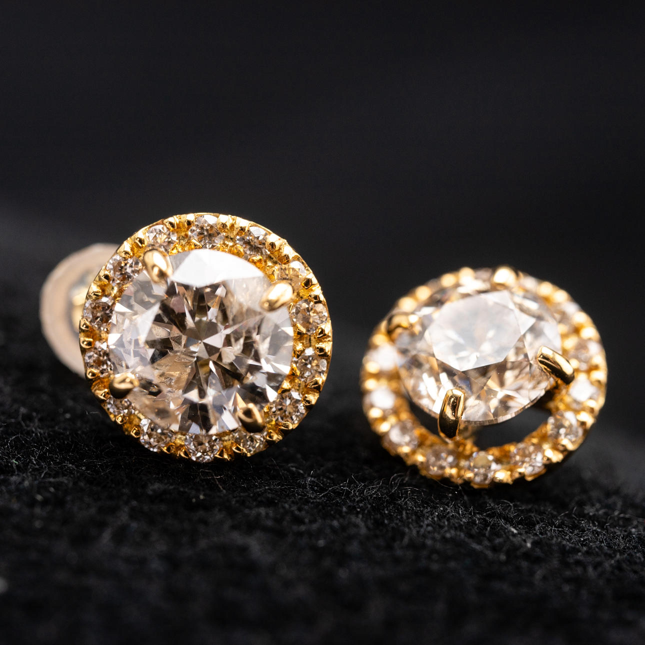 A pair of solitaire earrings.