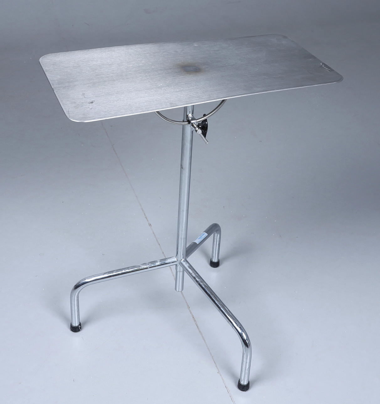 A metal arm operating table, 20th century. Raisable and tiltable plate ...