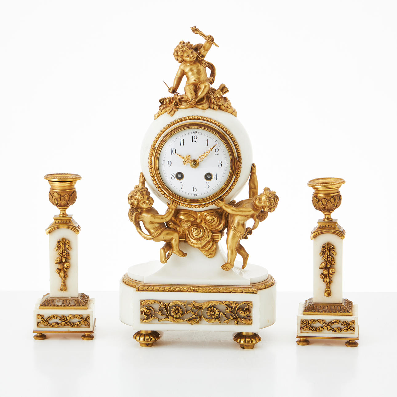 A 3-piece rococo table clock with candlesticks, France, circa 1900.