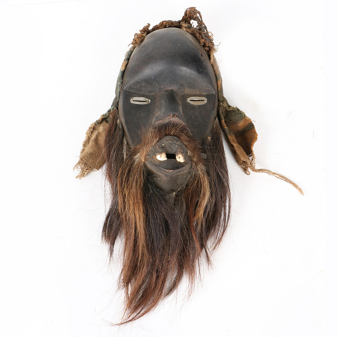 AN AFRICAN TRIBAL CARVED DAN MASK IVORY COAST/CÔTE D'IVOIRE ...