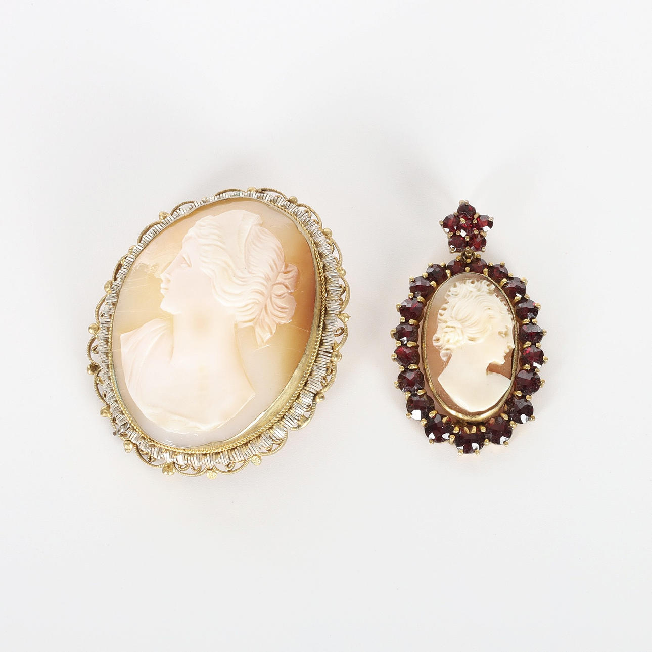 CAMEL BROOCH AND PENDANT, silver and garnets.