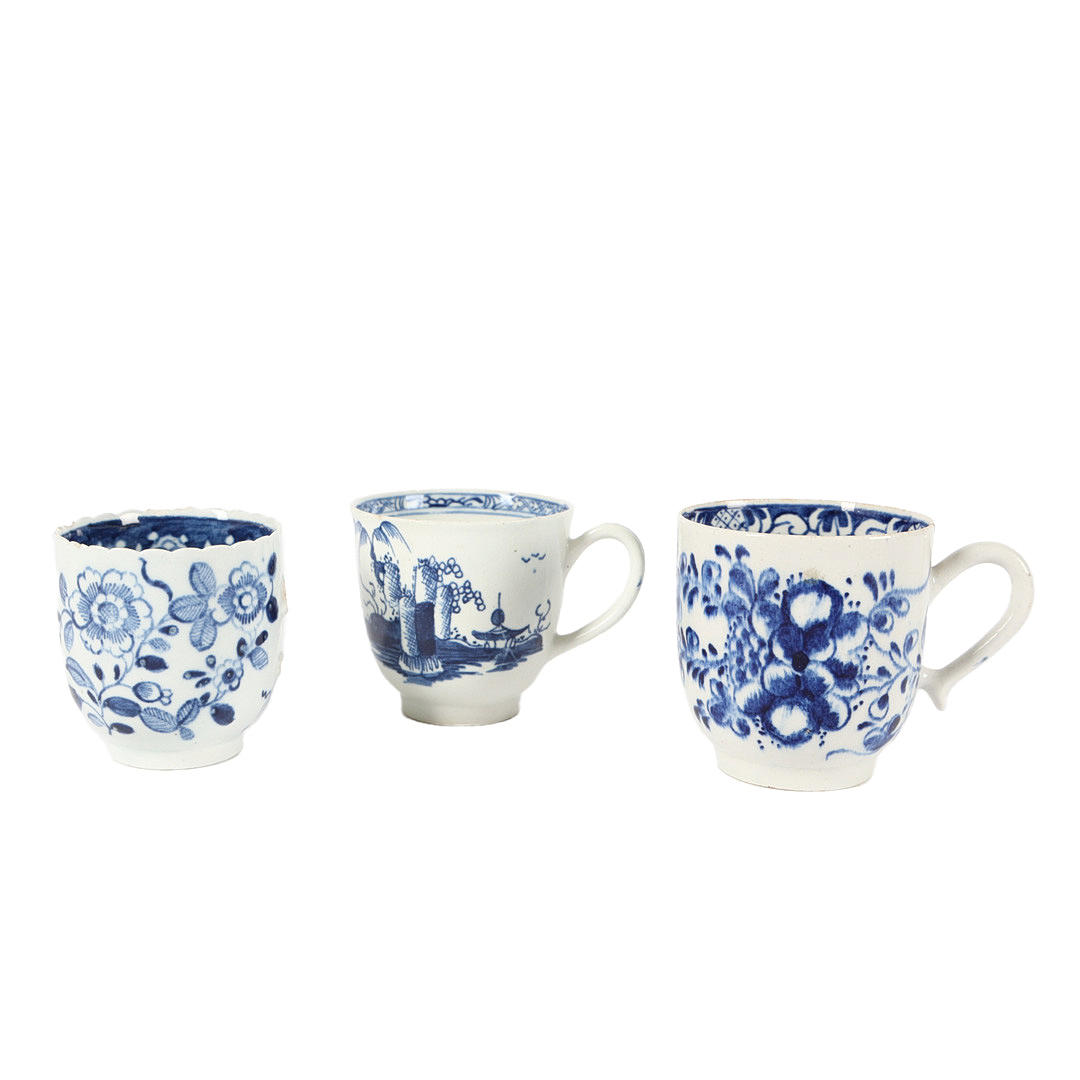 THREE 18TH CENTURY BLUE AND WHITE COFFEE CUPS.