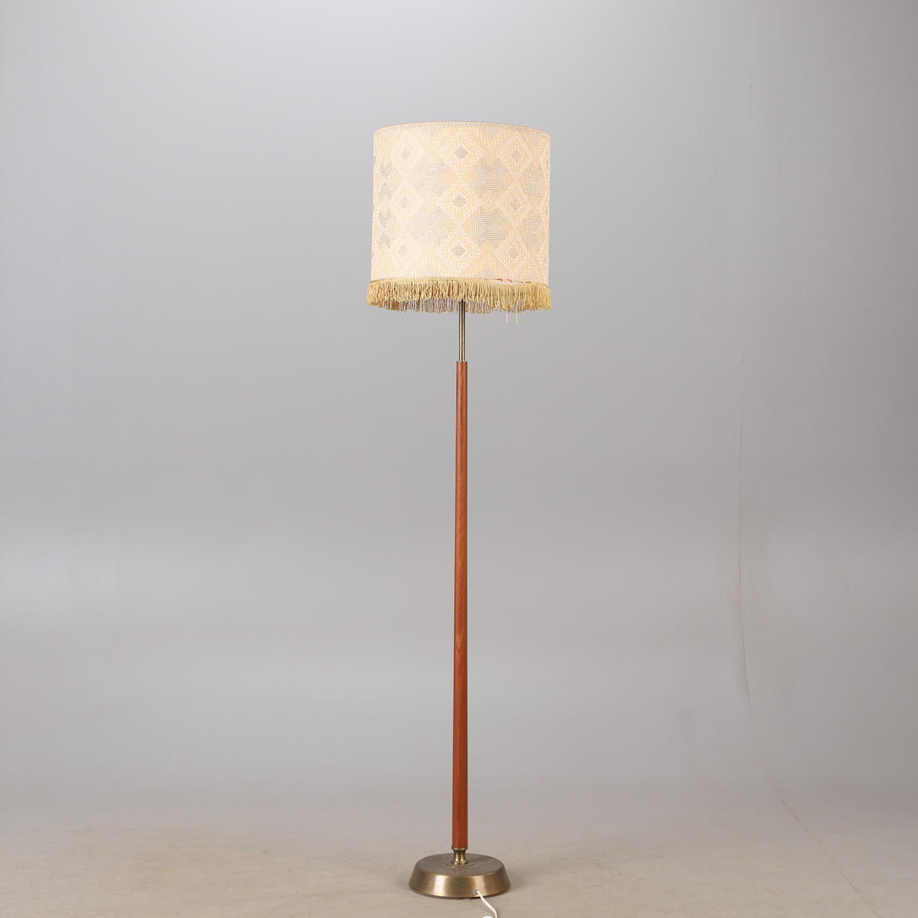A teak and brass floor lamp, mid 20th century.