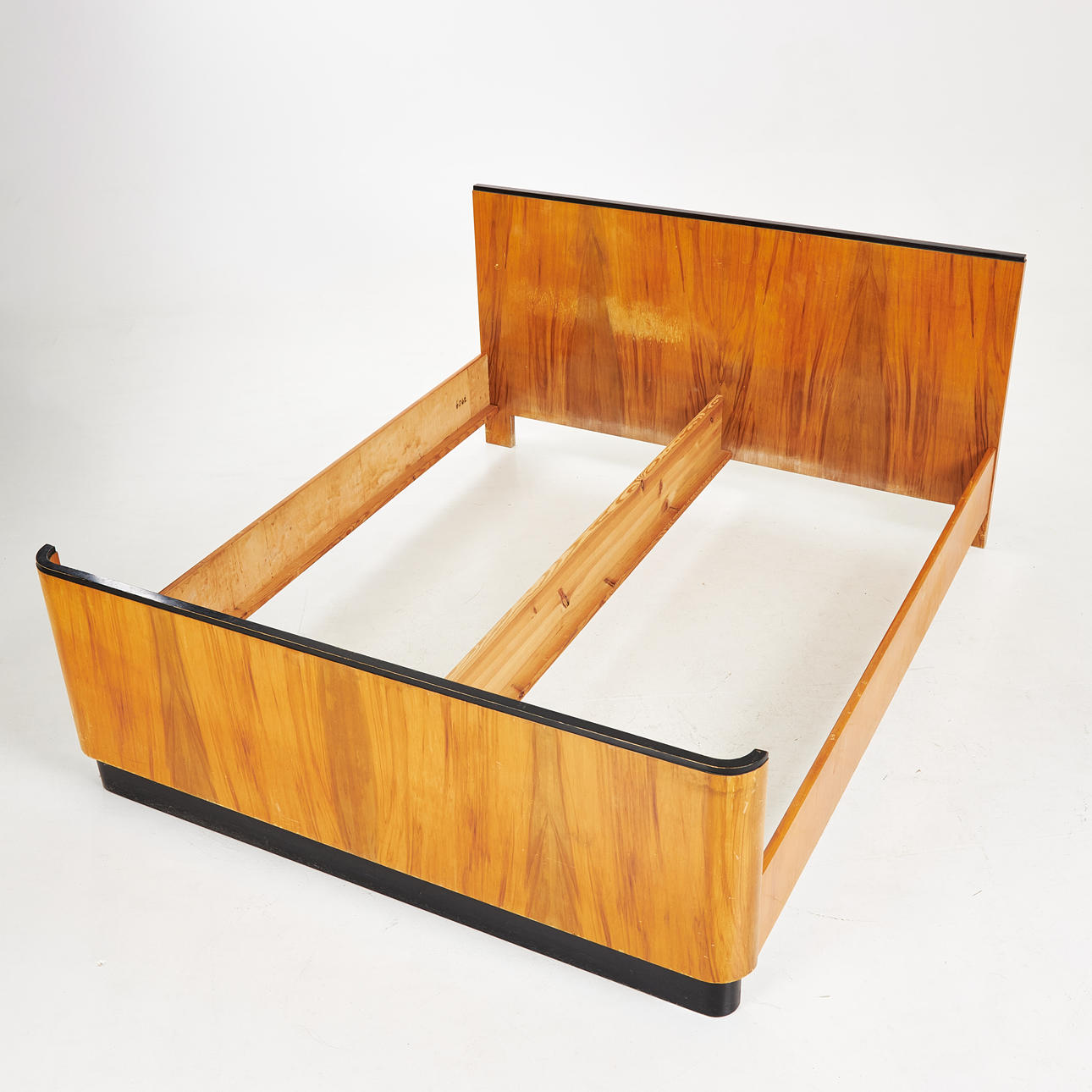 BED FRAME. 1930s, walnut and blackened details.