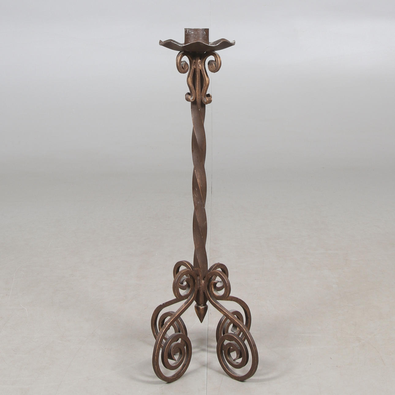 A wrought iron floor candlestick, 20th century.