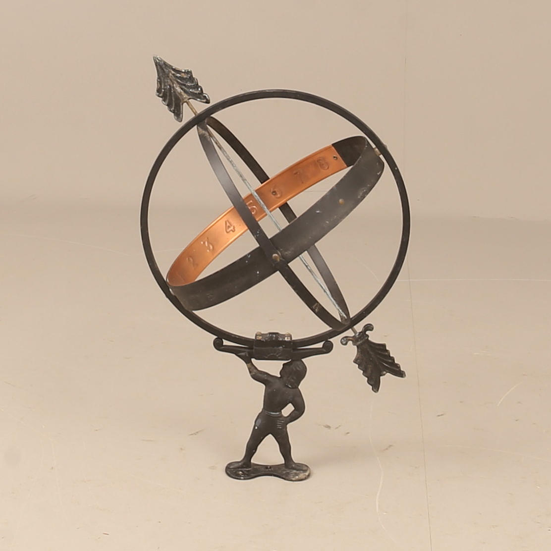 A metal sundial, 20th century.