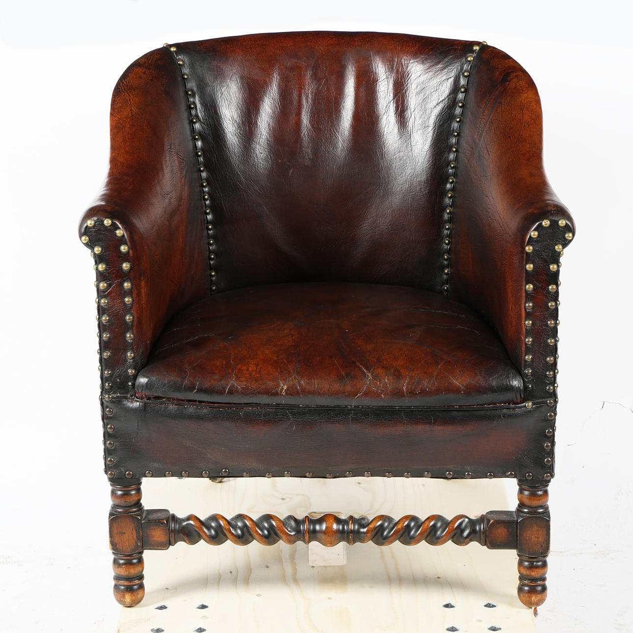 A 20TH CENTURY LEATHER STUDDED ARMCHAIR.