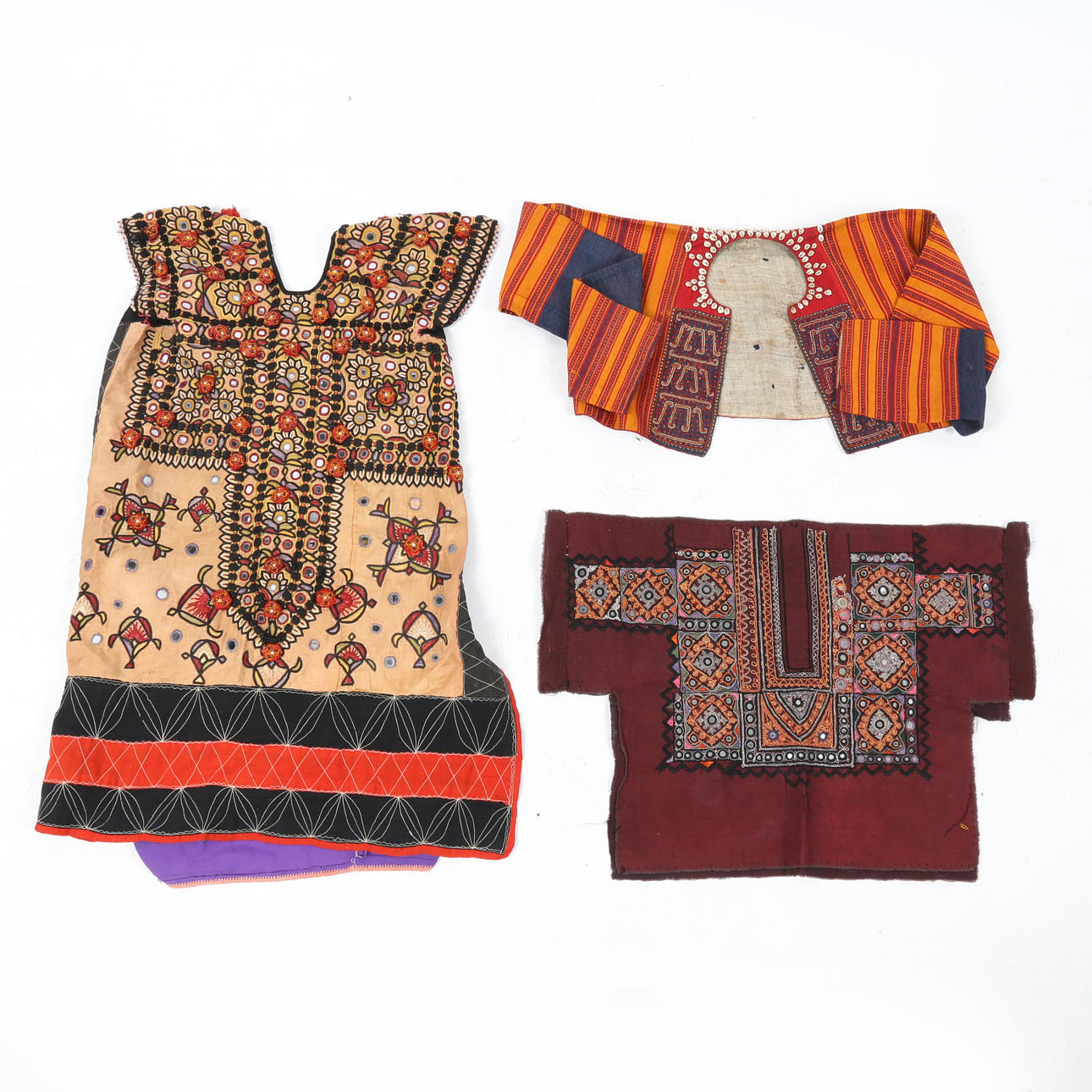 THREE TRIBAL GARMENTS, 20TH CENTURY (3).