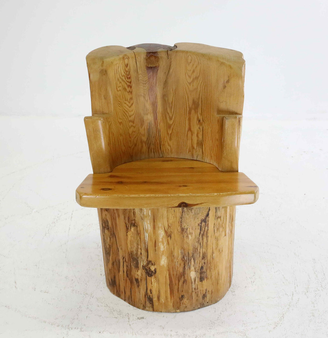 A 20th century pine stump chair.