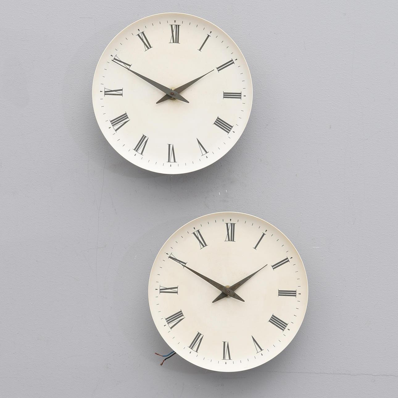 A pair of wall clocks by Henning Koppel for Louis Poulsen. Clocks
