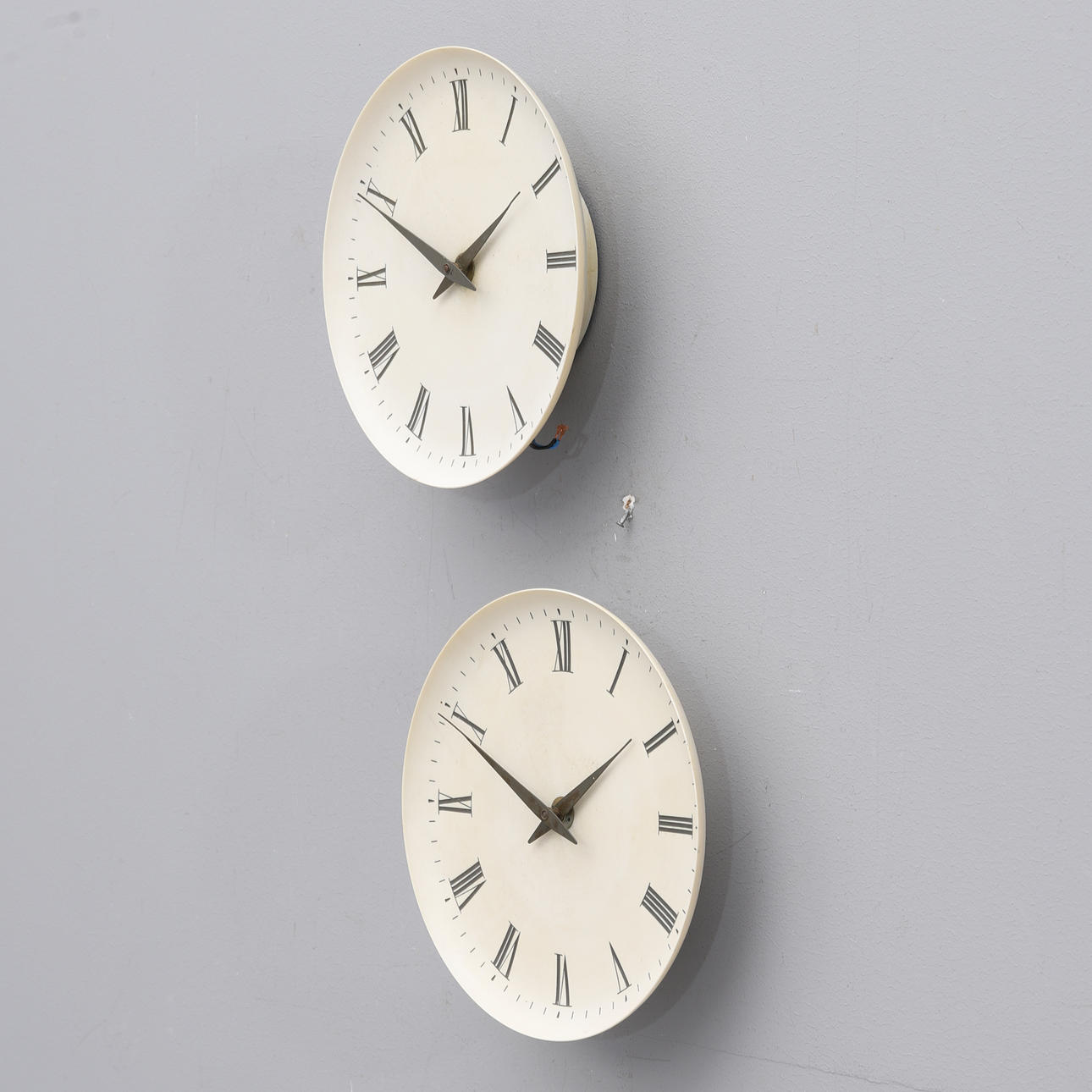 A pair of wall clocks by Henning Koppel for Louis Poulsen. Clocks