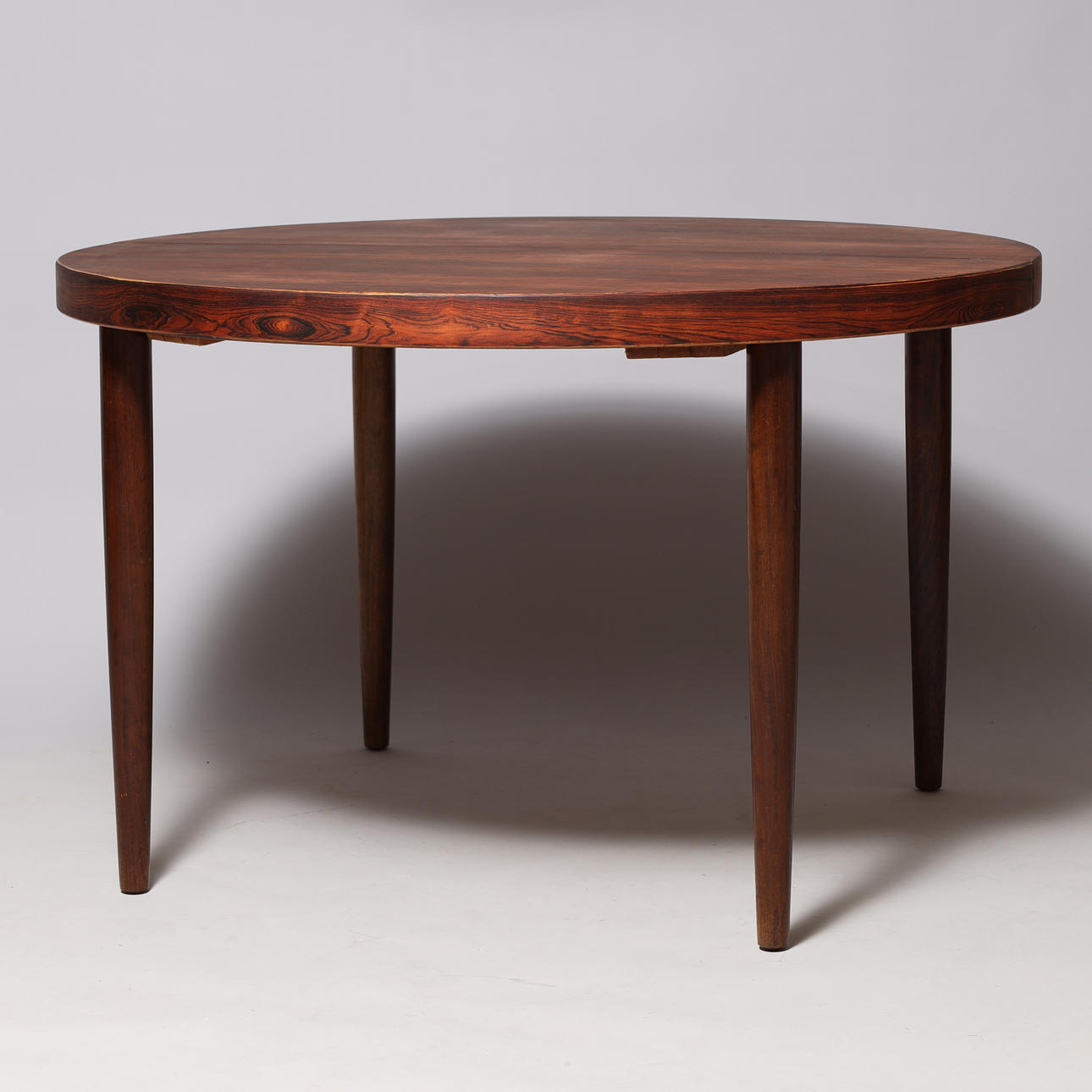 VILLY SCHOU ANDERSEN. Circular rosewood pull-out table with two additional plates, Schou Andersen, Denmark, circa 1960s, (3).
