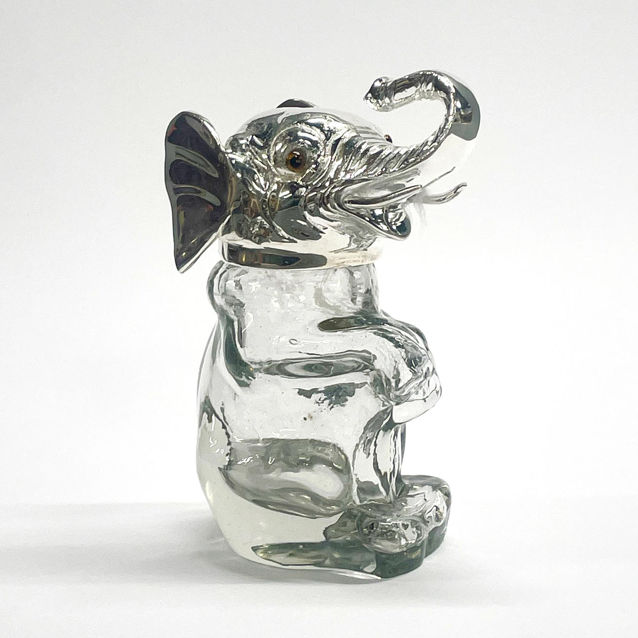 SILVER PLATED GLASS ELEPHANT BOTTLE.