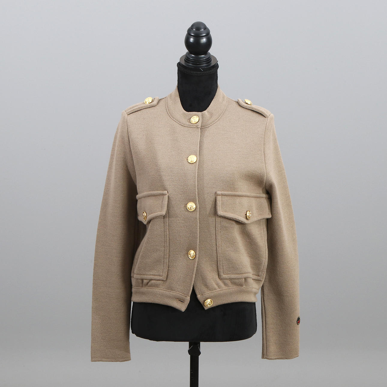 BUSNEL, JACKET. Beige wool with brass-colored buttons.