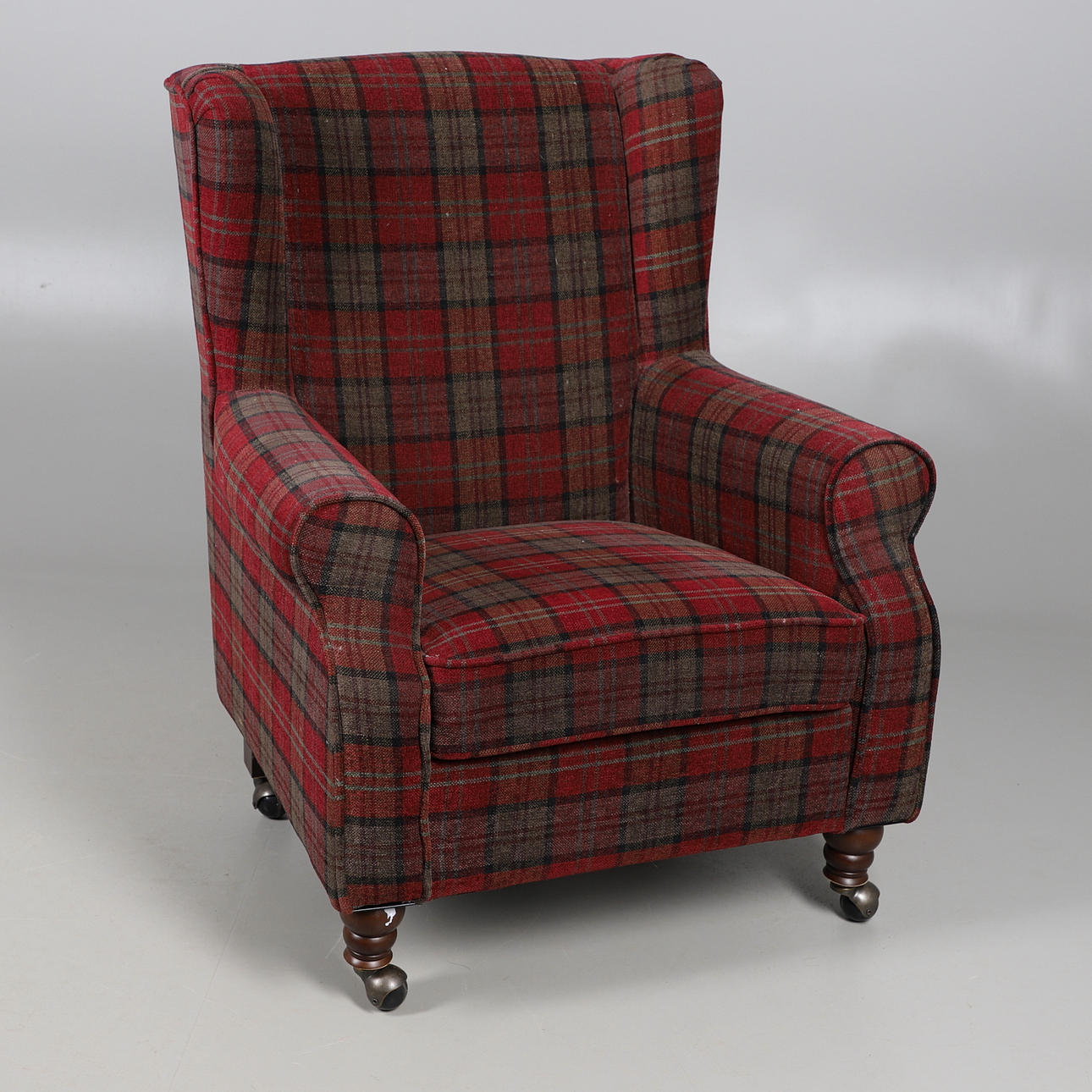 A TARTAN PATTERN UPHOLSTERED SMALL WING BACK ARMCHAIR.