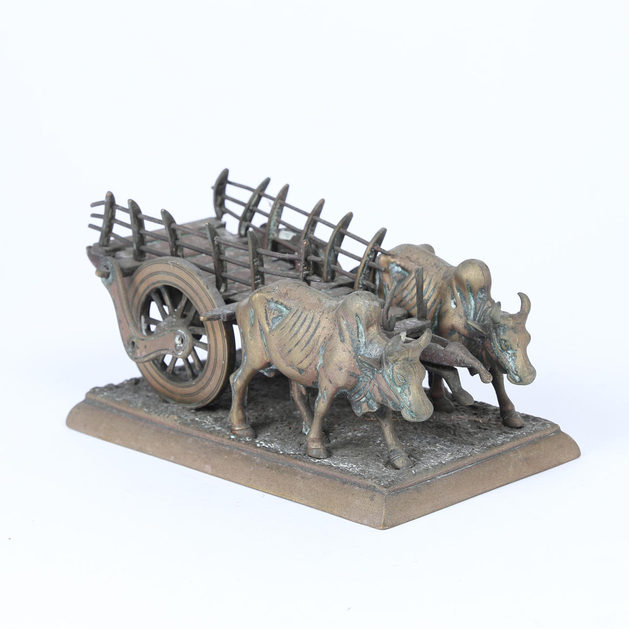 A BRASS MODEL OF CATTLE PULLING A CART.