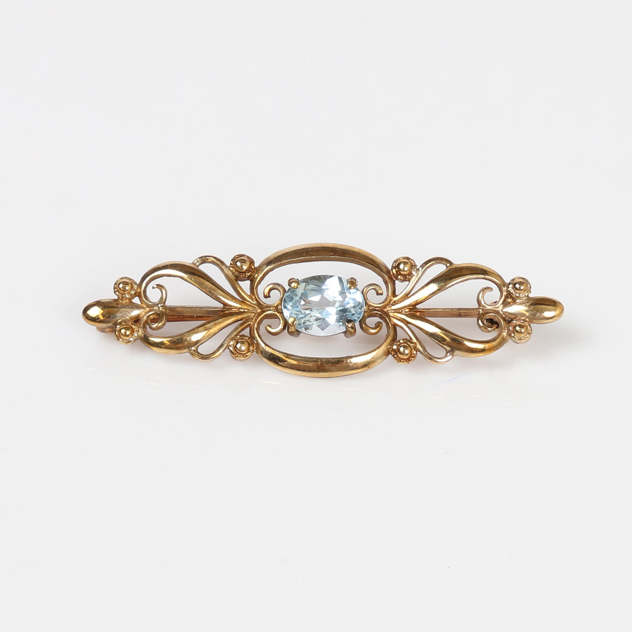 9 KARAT GULD HIMMELBLÅ TOPAS BROCHE.