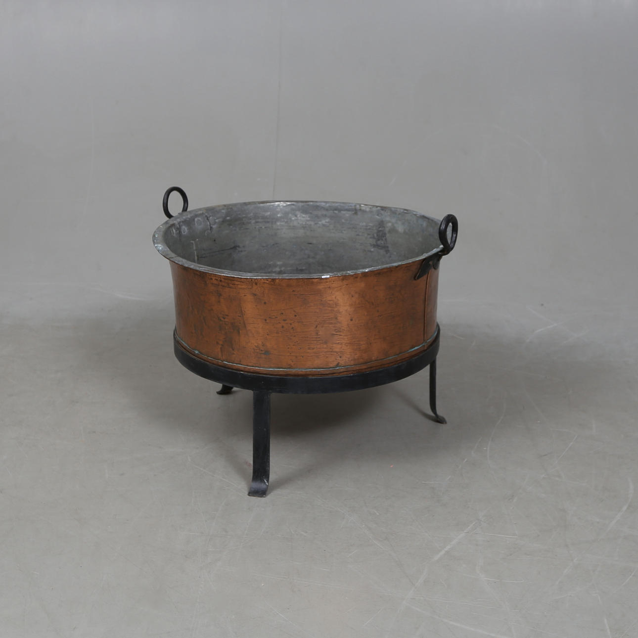 COPPER KETTLE/FIREWOOD ON METAL RACK.