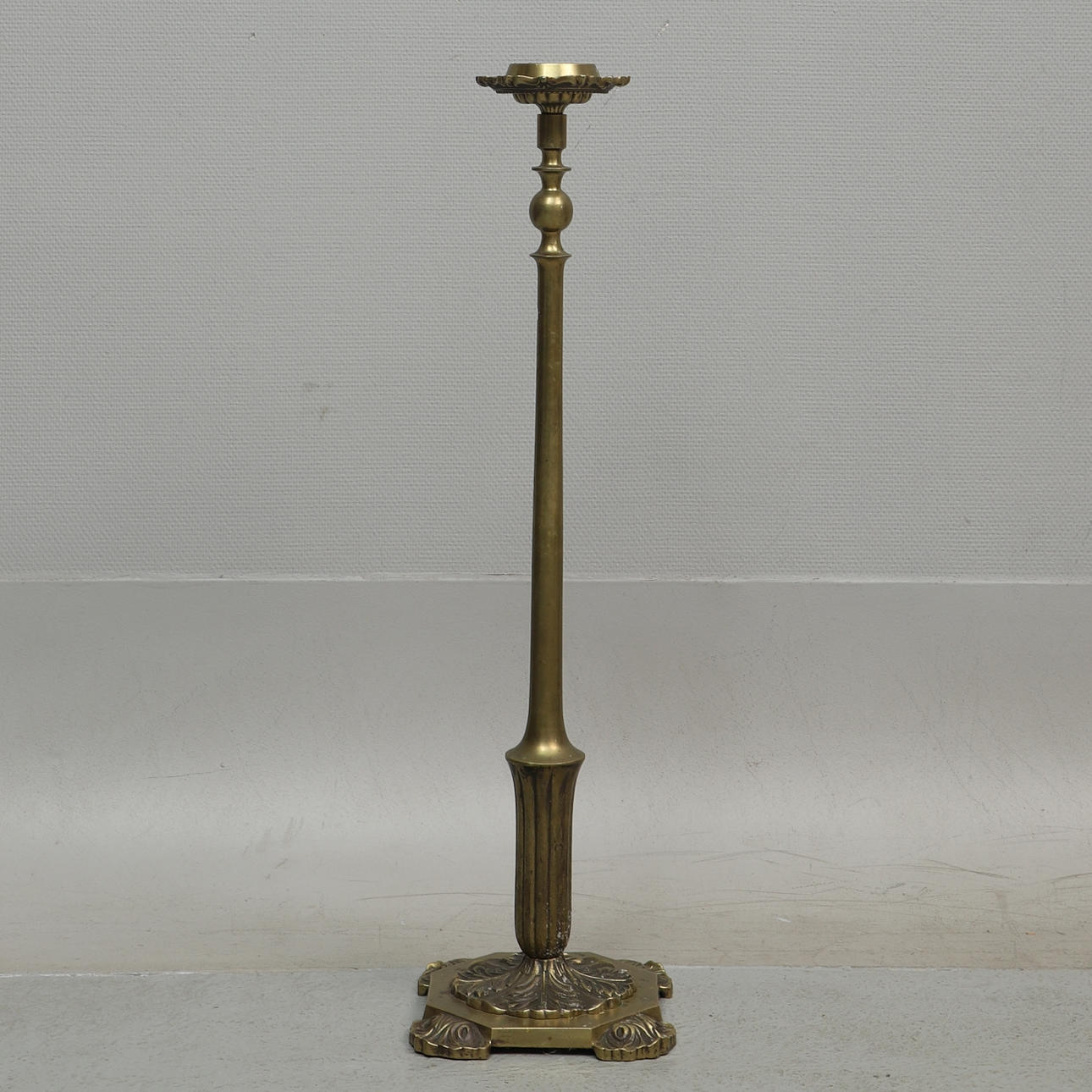 A floor candlestick, probably ore, 20th century.