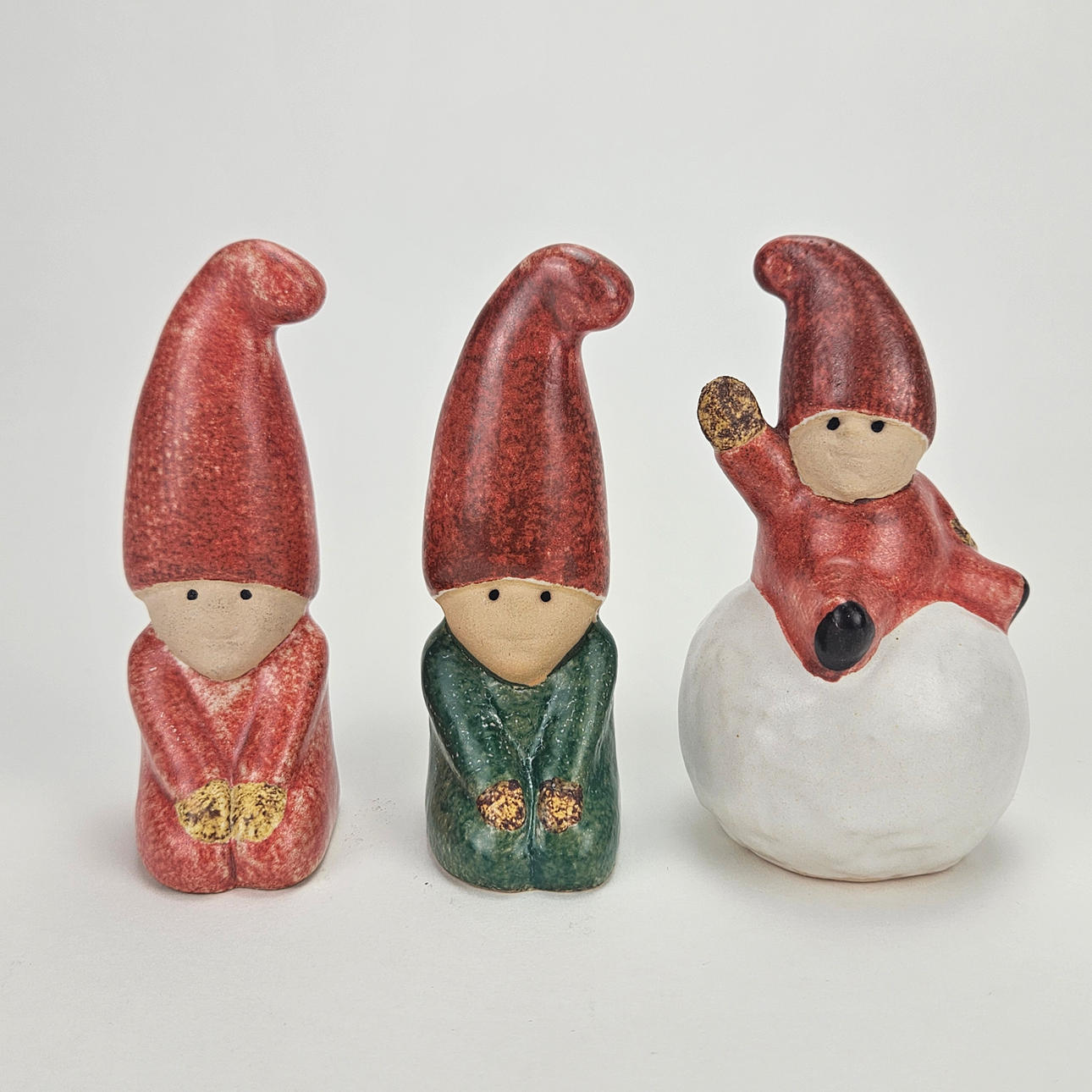 LISA LARSON. Three ceramic figurines, Santa tennis, signed.