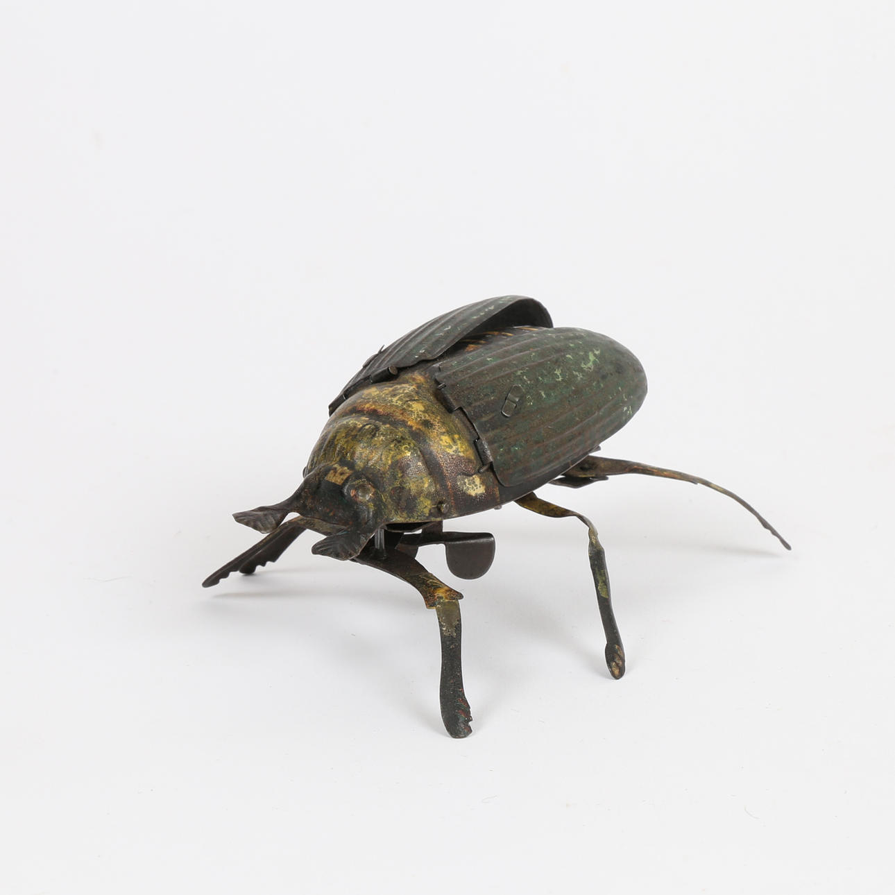 A TIN PLATE CLOCKWORK BEETLE.