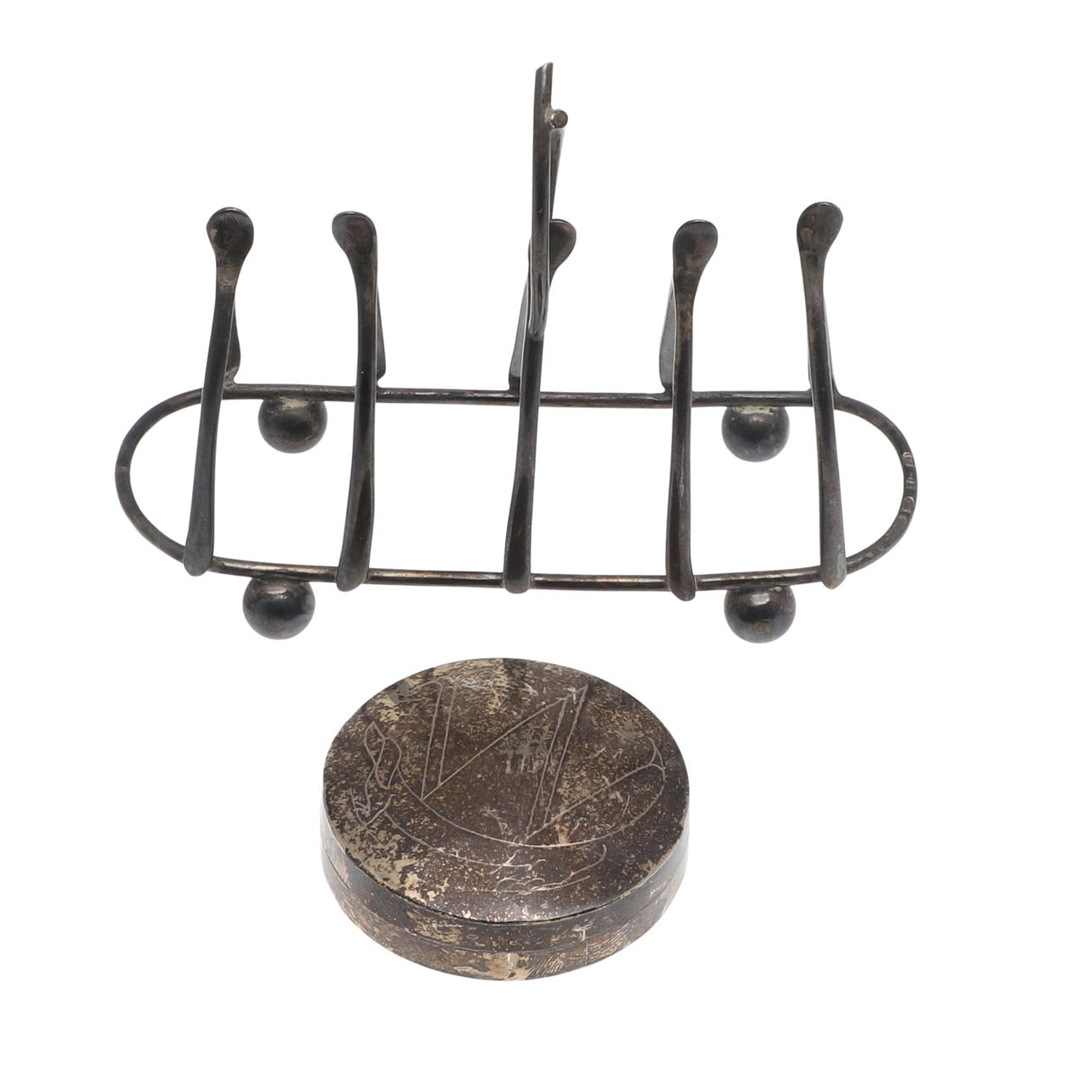 A SILVER TOAST RACK AND PILL BOX.