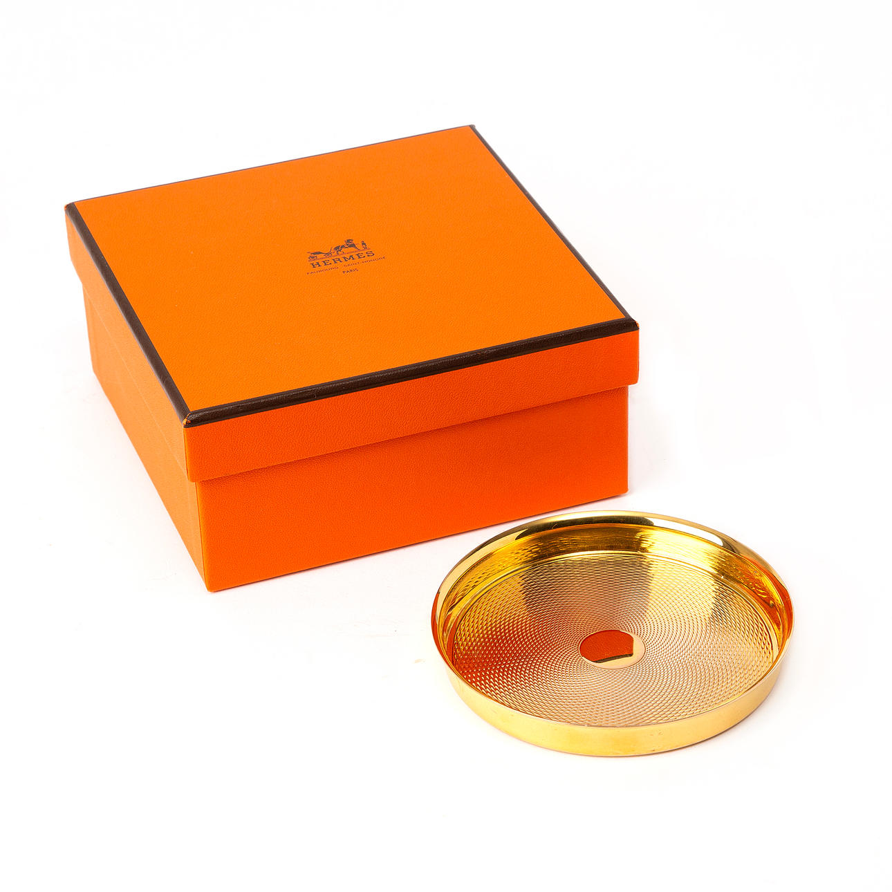A HERMÈS coaster, gold-plated silver.