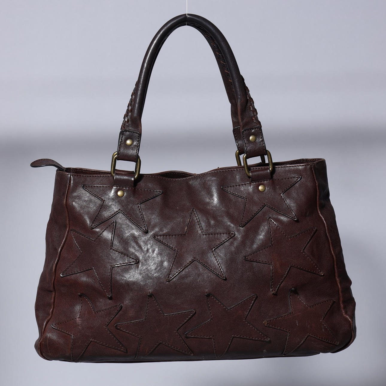 RIKA. “Star bag” handbag, dark brown leather.