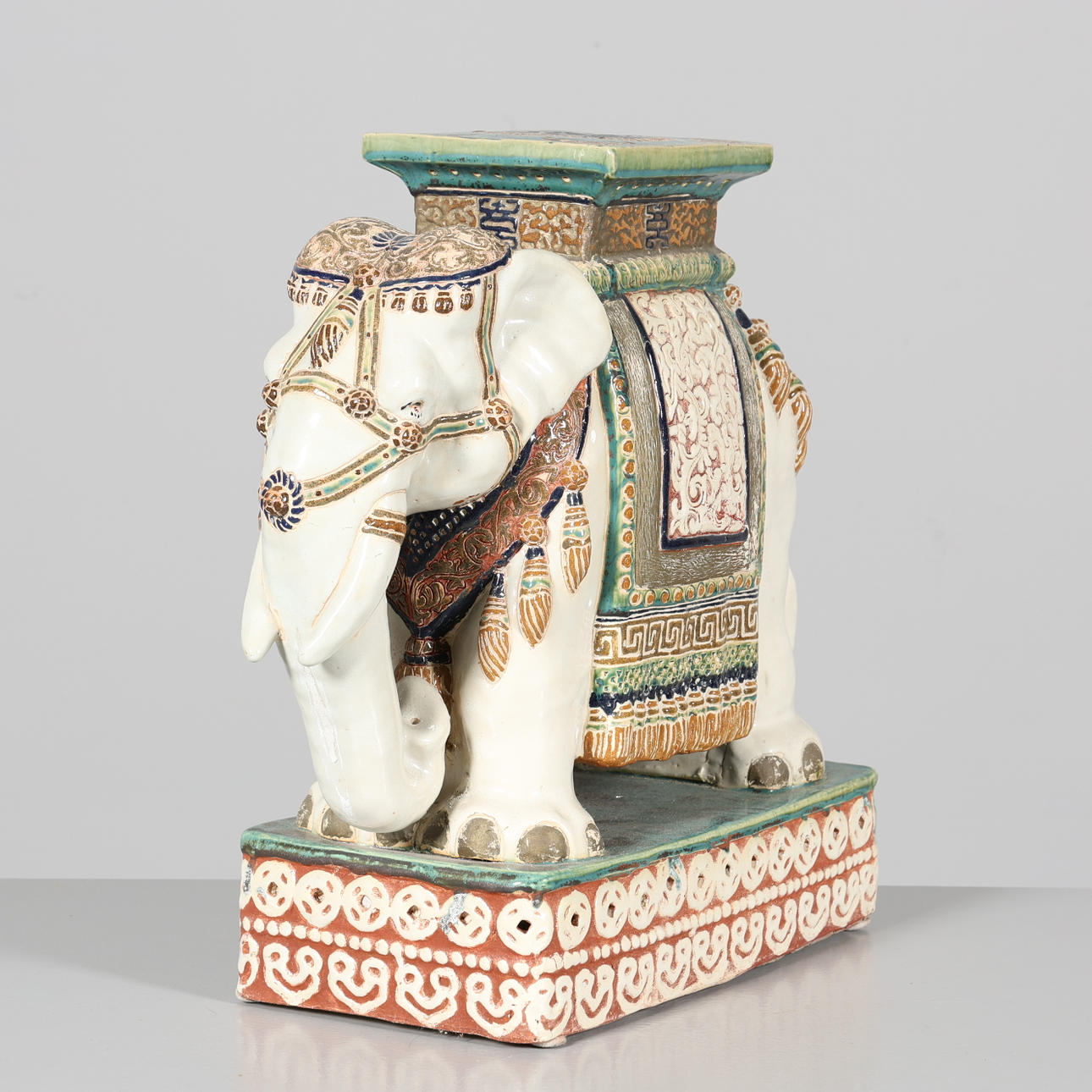 A ceramic elephant pedestal.