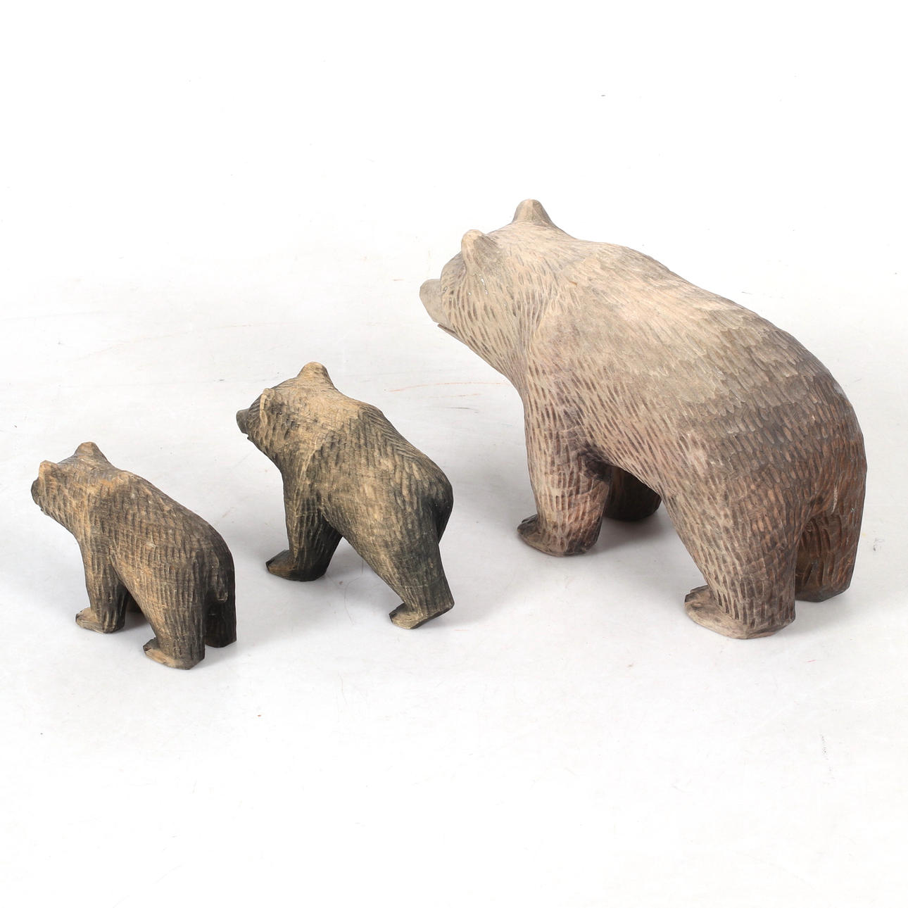 ARVID NORDLUND. Three carved wooden figurines, bears, monogrammed