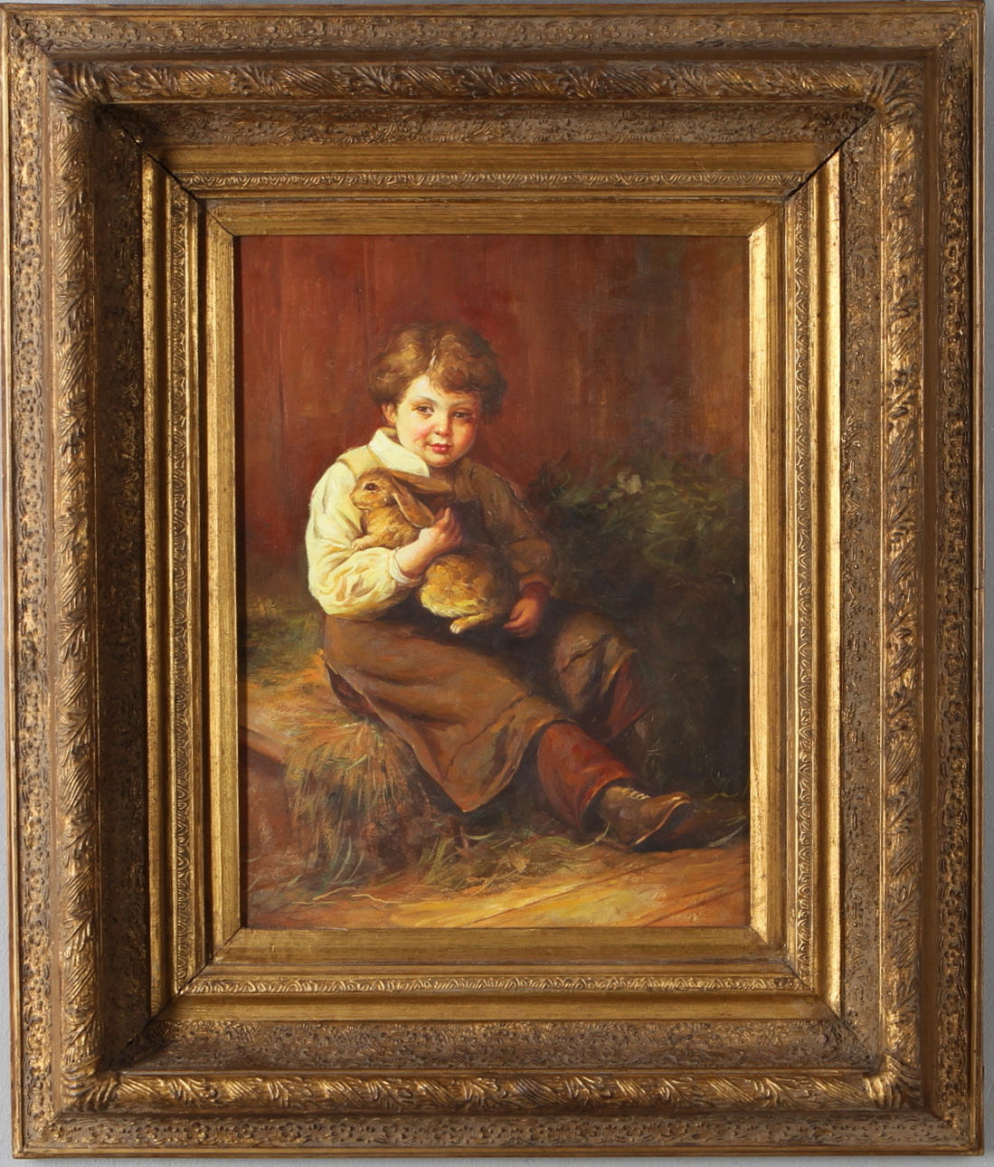 OIDENTIFIERAD KONSTNÄR. Pojke med kanin, olja på pannå, otydlig signatur. 1900-tal.