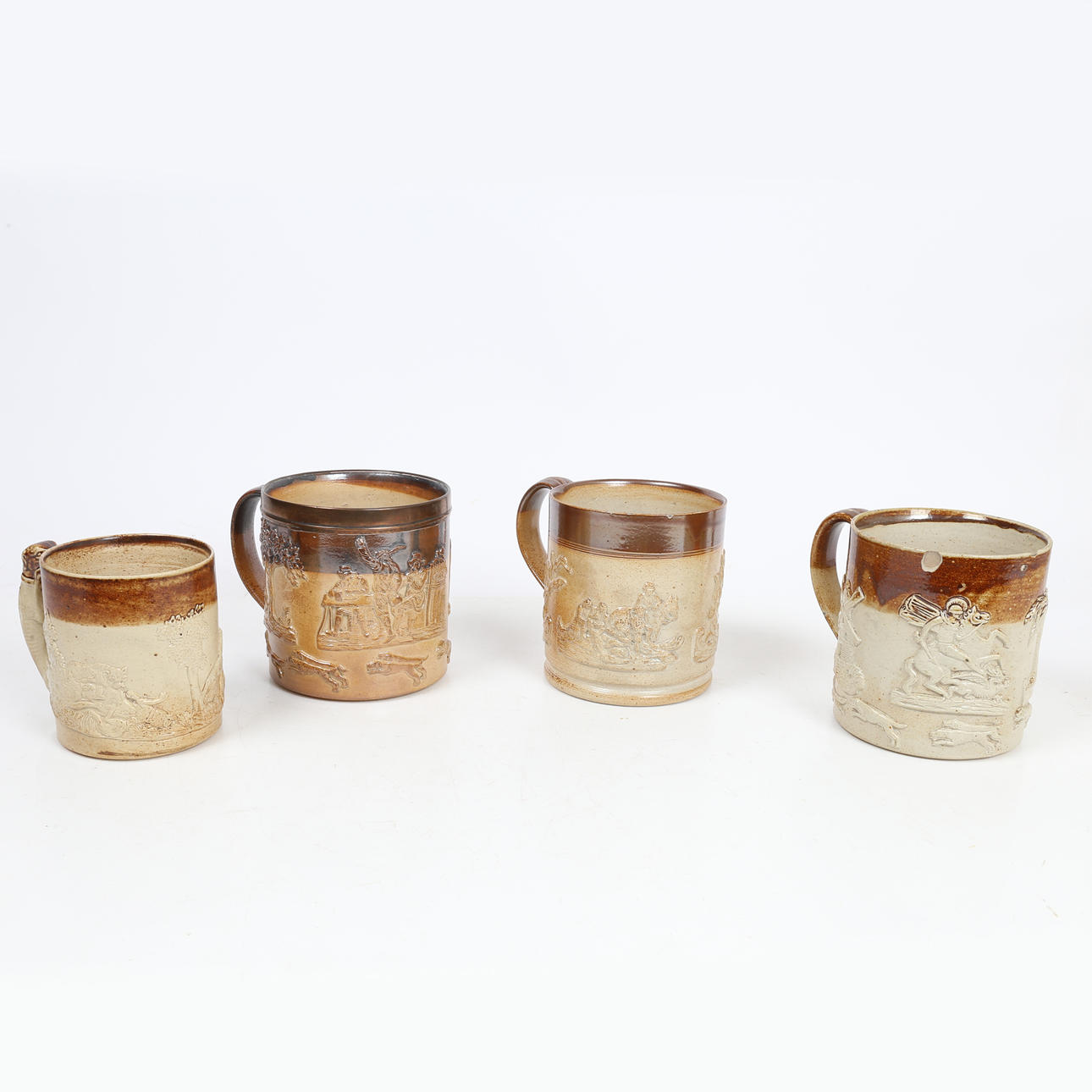 FOUR 19TH CENTURY STONEWARE MUGS.
