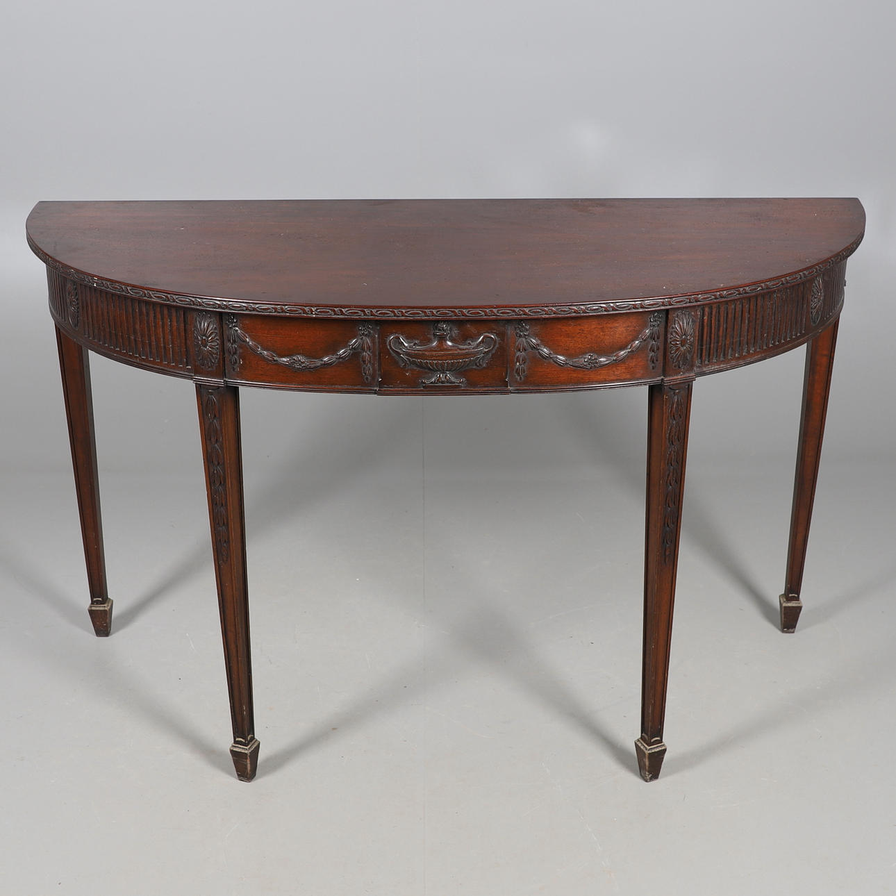 A MAHOGANY DEMI LUNE SIDE TABLE.