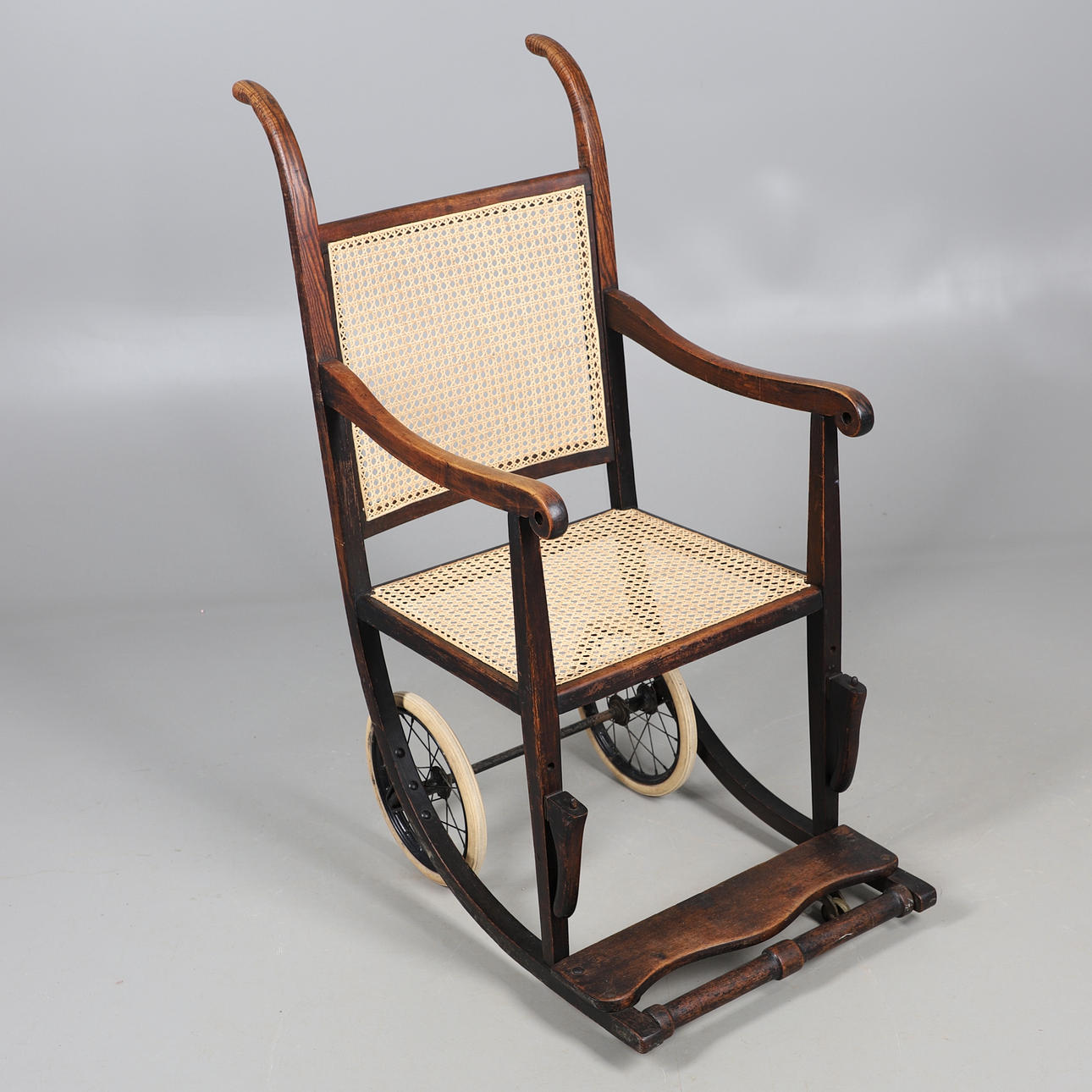 A VICTORIAN BEECH AND CANE INVALID'S WHEELCHAIR.