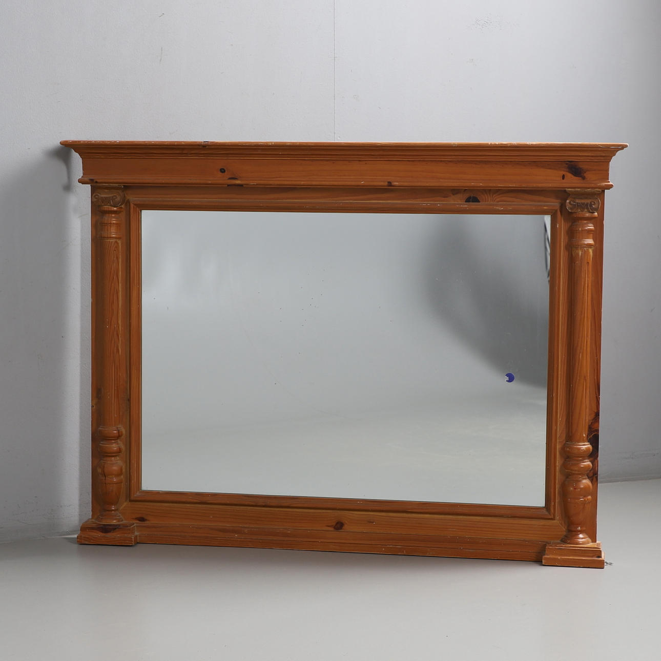 A MODERN PINE FRAMED OVERMANTEL MIRROR.