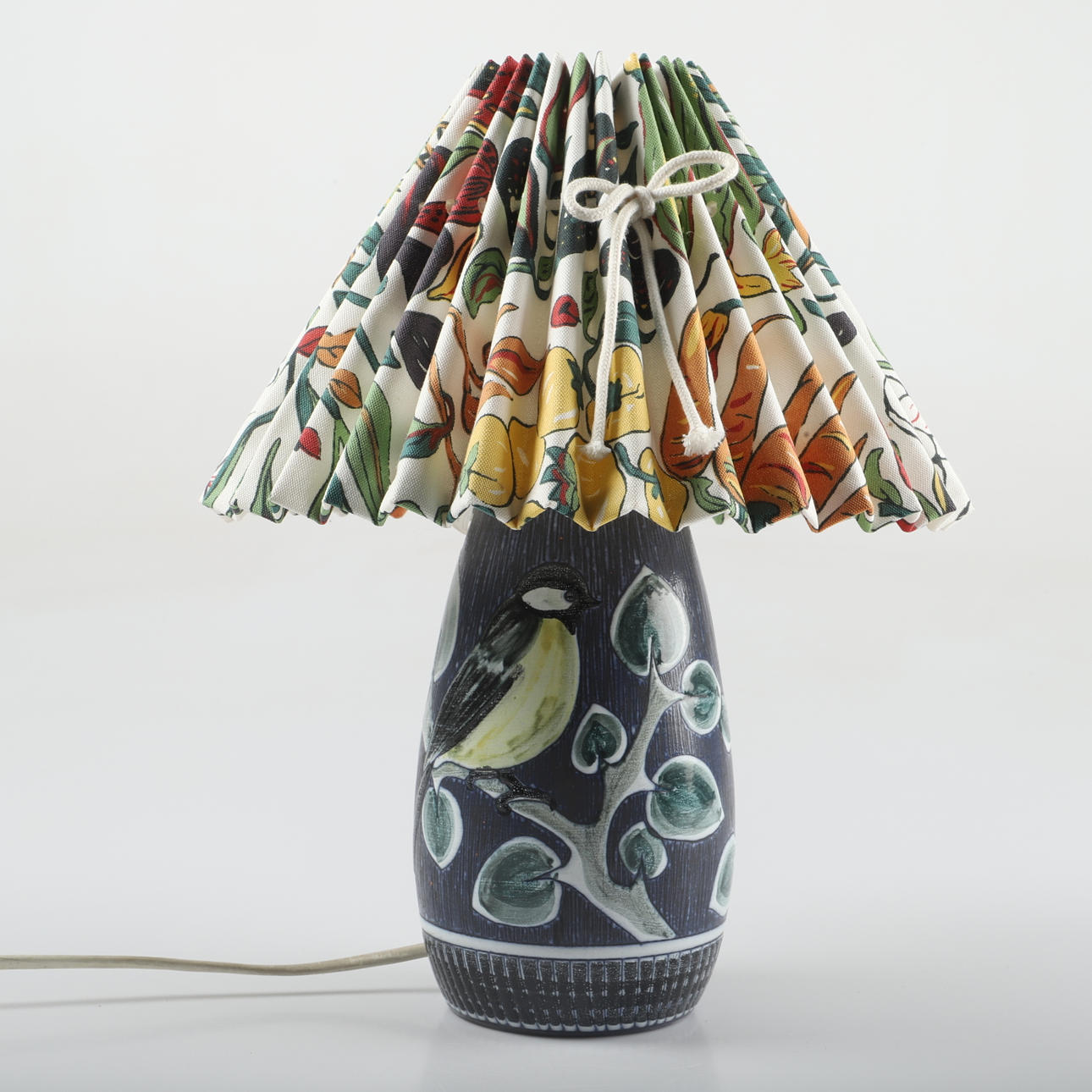 A ceramic table lamp with textile shade, 20th century.