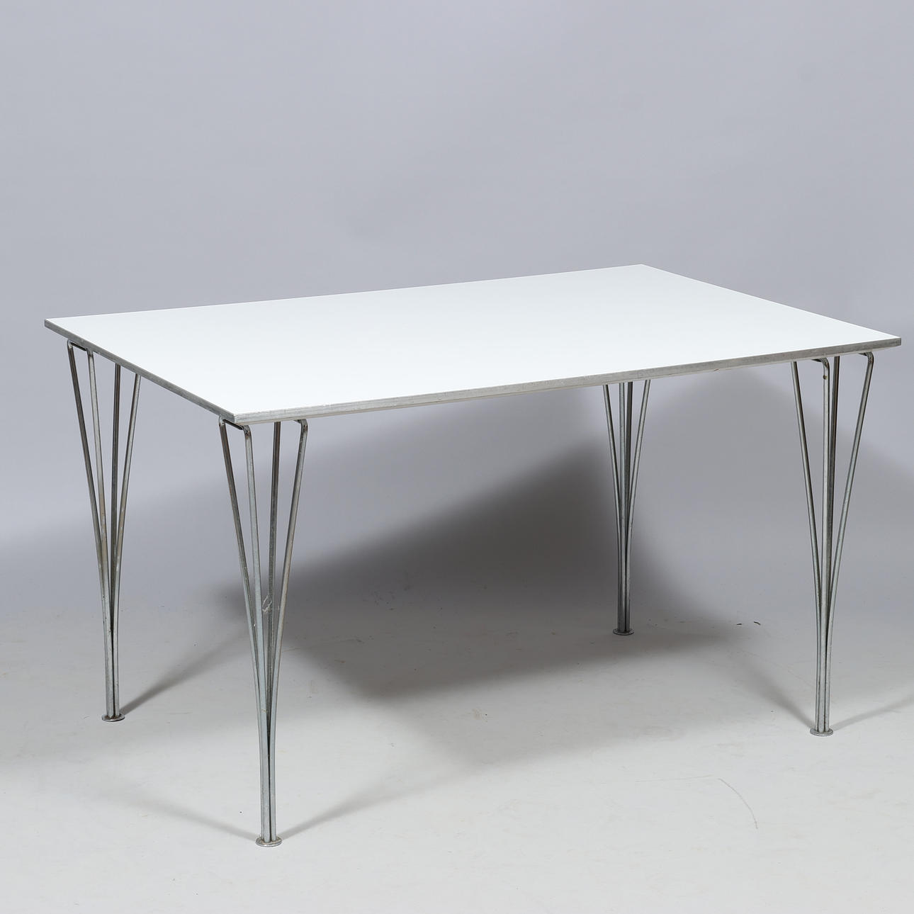 PIET HEIN. Rectangular dining table, white laminate top, chrome-plated metal clamps, Fritz Hansen, Denmark.