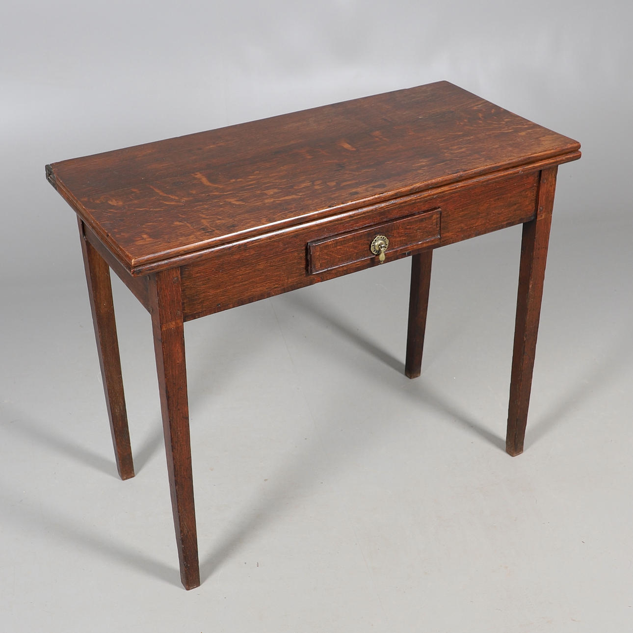 A 19TH CENTURY OAK TEA TABLE.
