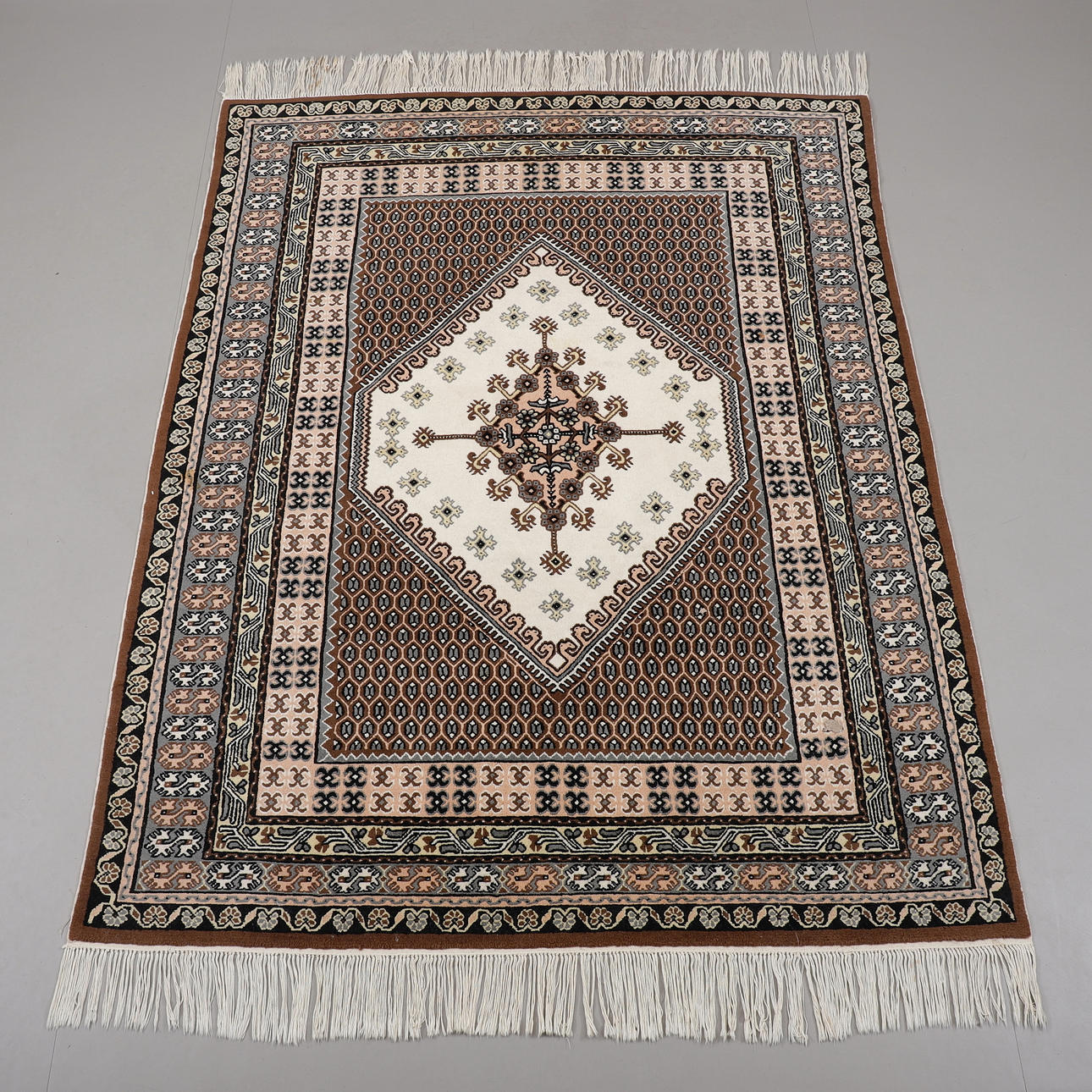 A TUNISIAN CARPET, 266 x 202 cm.