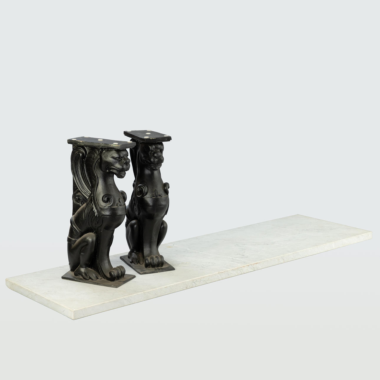 marble table/wall console with 2 chimeras as table supports.
