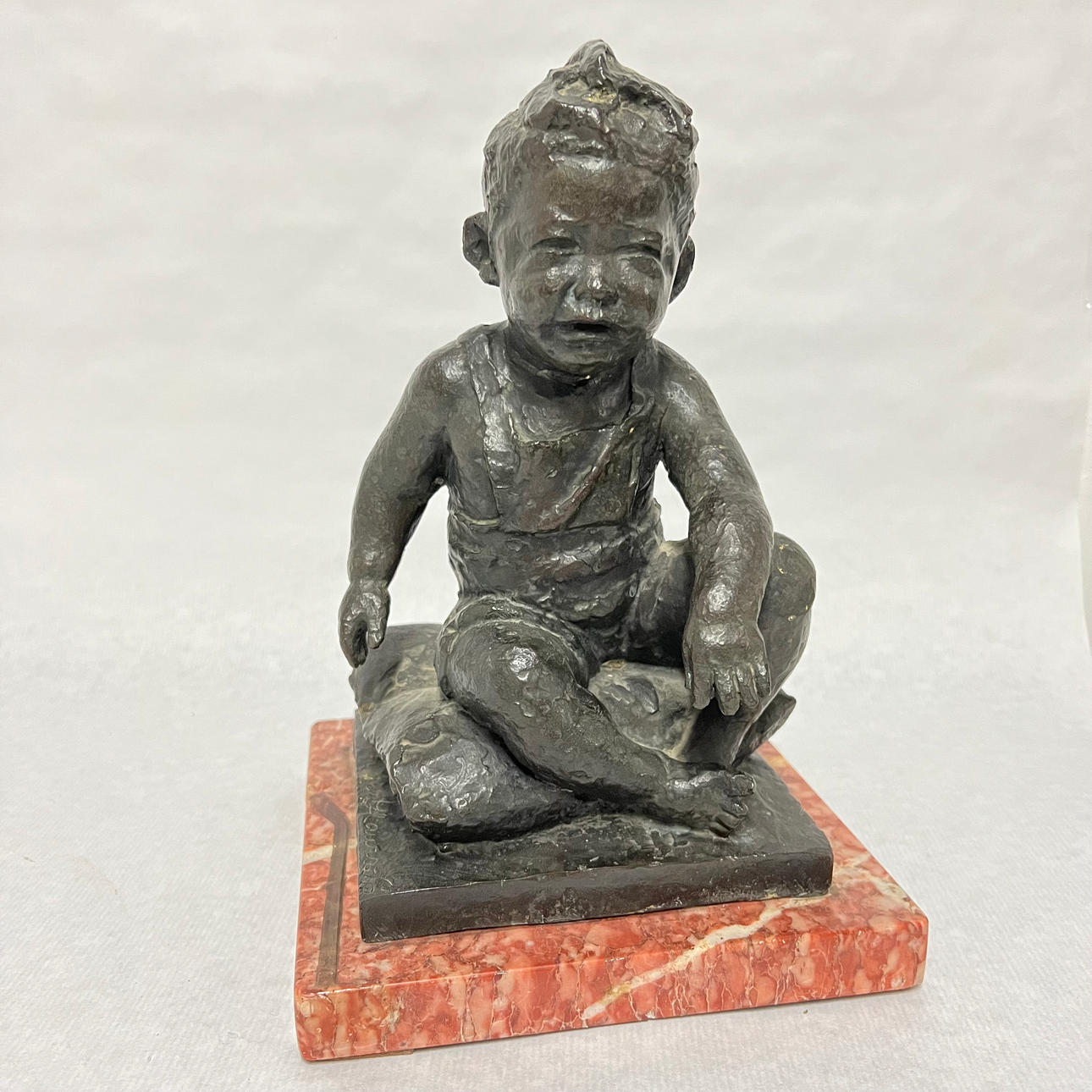 MARTÍ LLAURADÓ. Child seated. Bronze sculpture on marble base.